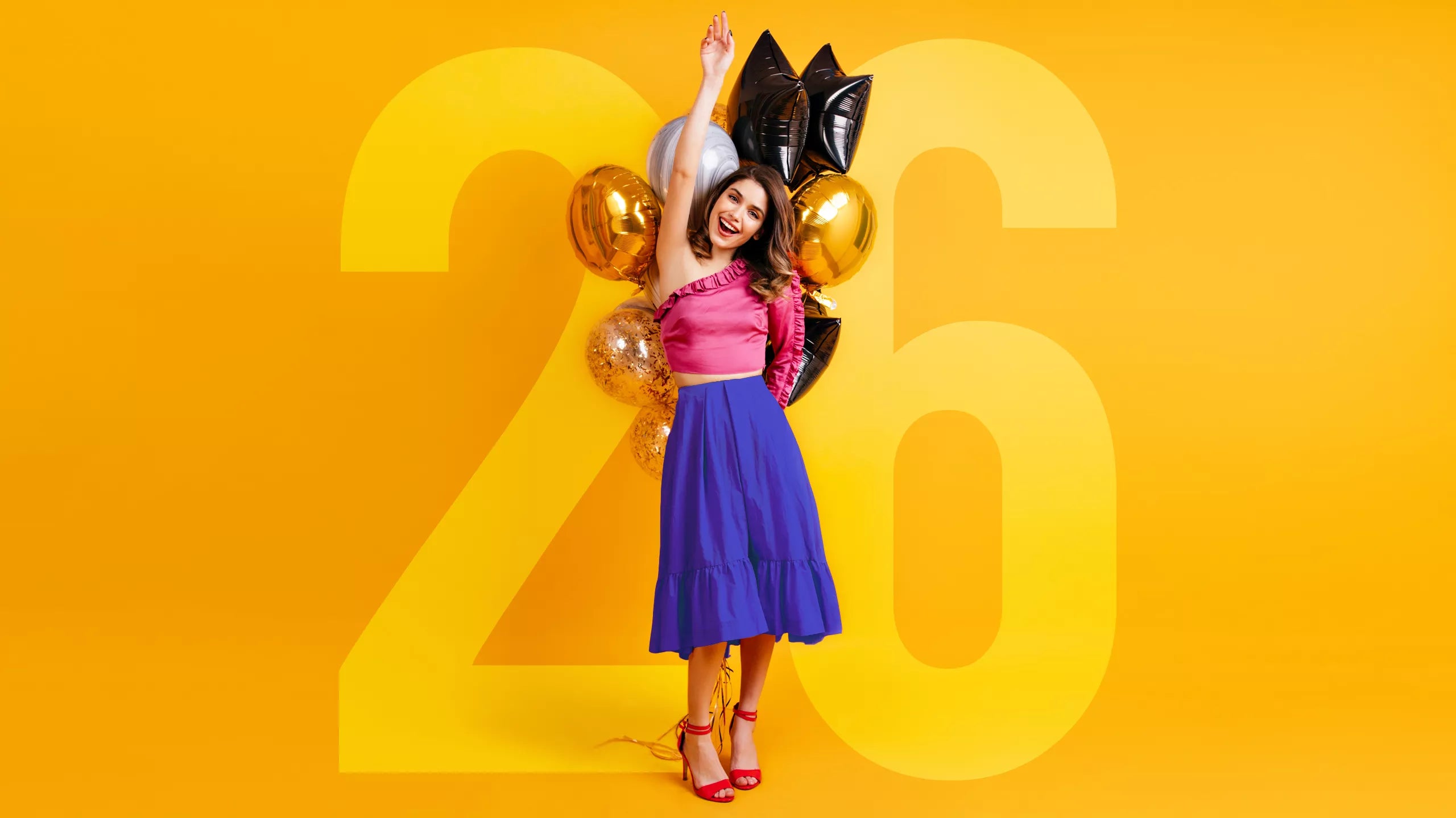 Woman with balloons shaped like the number 26 on a yellow background celebrating our 26th birthday with 26% off site wide
